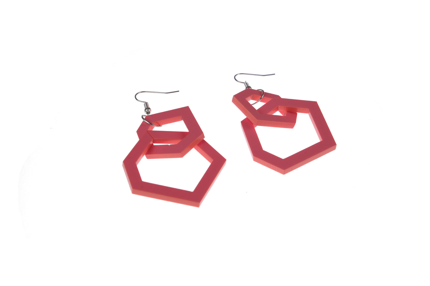 coral pink geometric hoop earrings on a white background