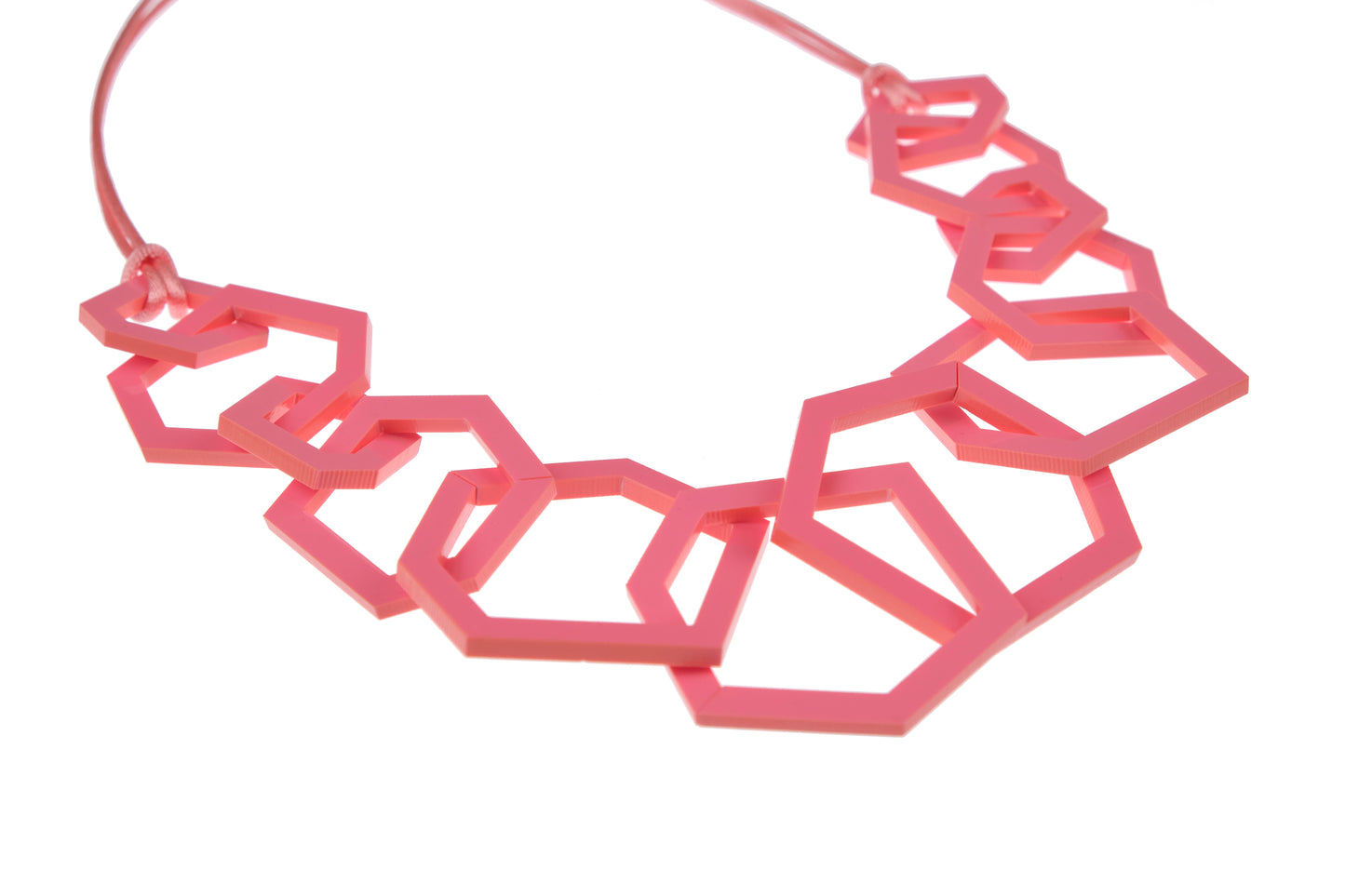 Pink geometric necklace on a white background