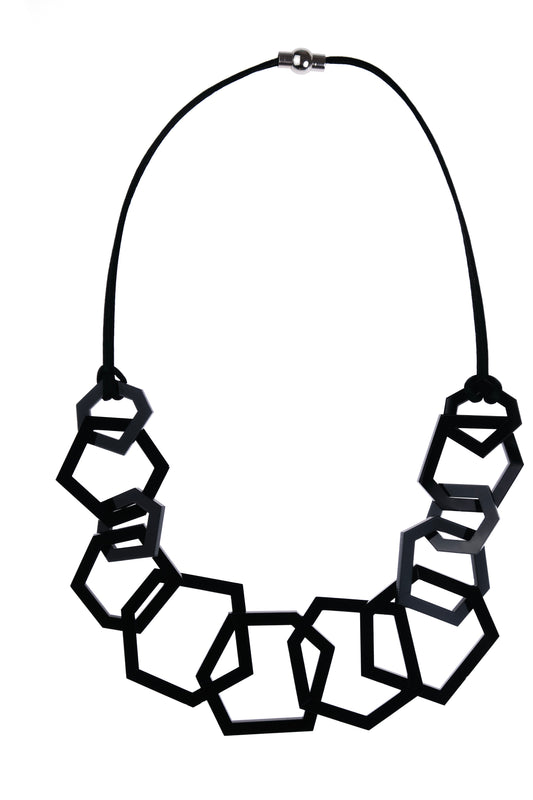 Black geometric acrylic necklace on white background