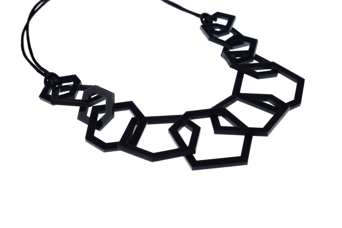 Black geometric necklace on a white background