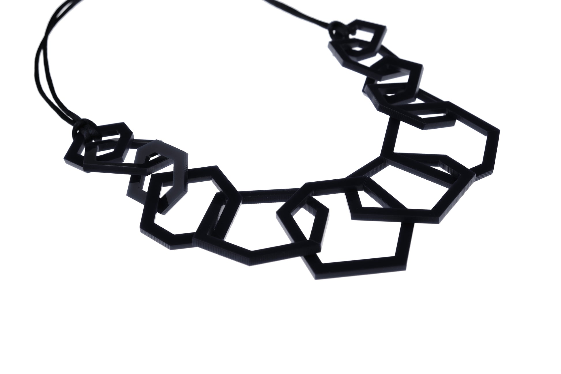 Black geometric necklace on a white background