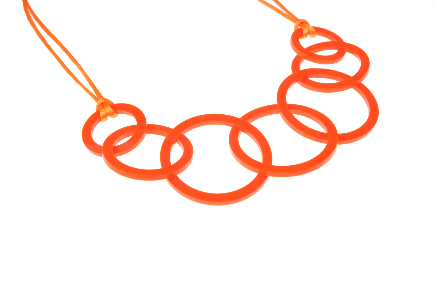 Orange necklace with interlocking rings on a white background