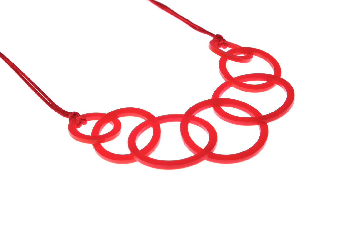 Red necklace with interlocking rings on a white background