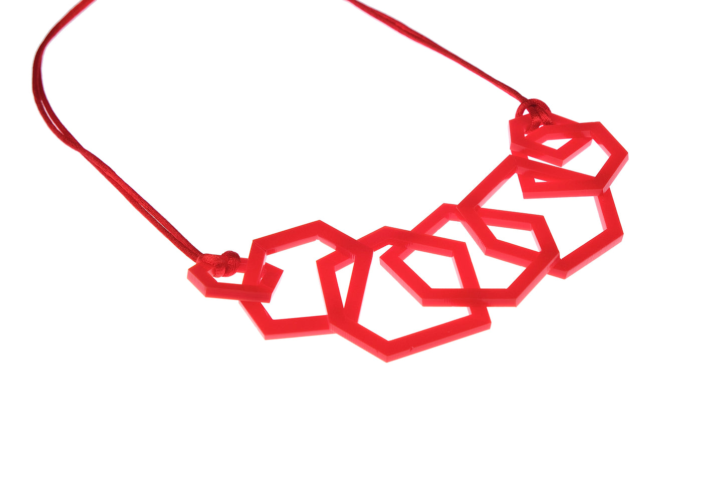 Red geometric necklace on a white background