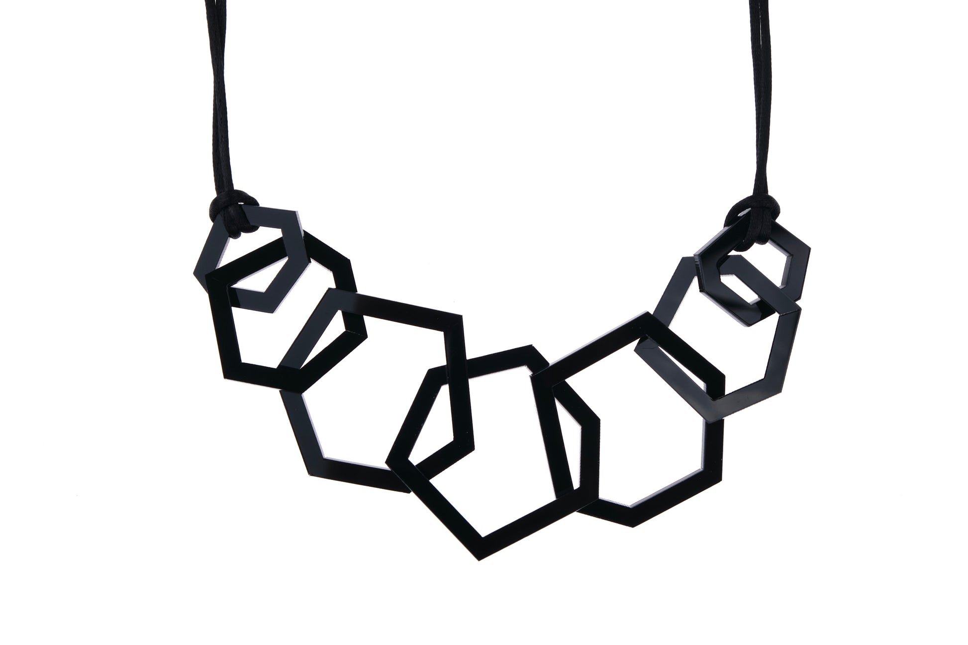 Black geometric necklace on a white background