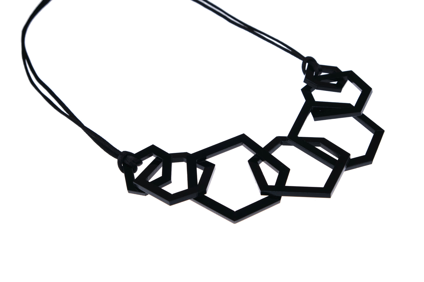 Black geometric necklace on a white background