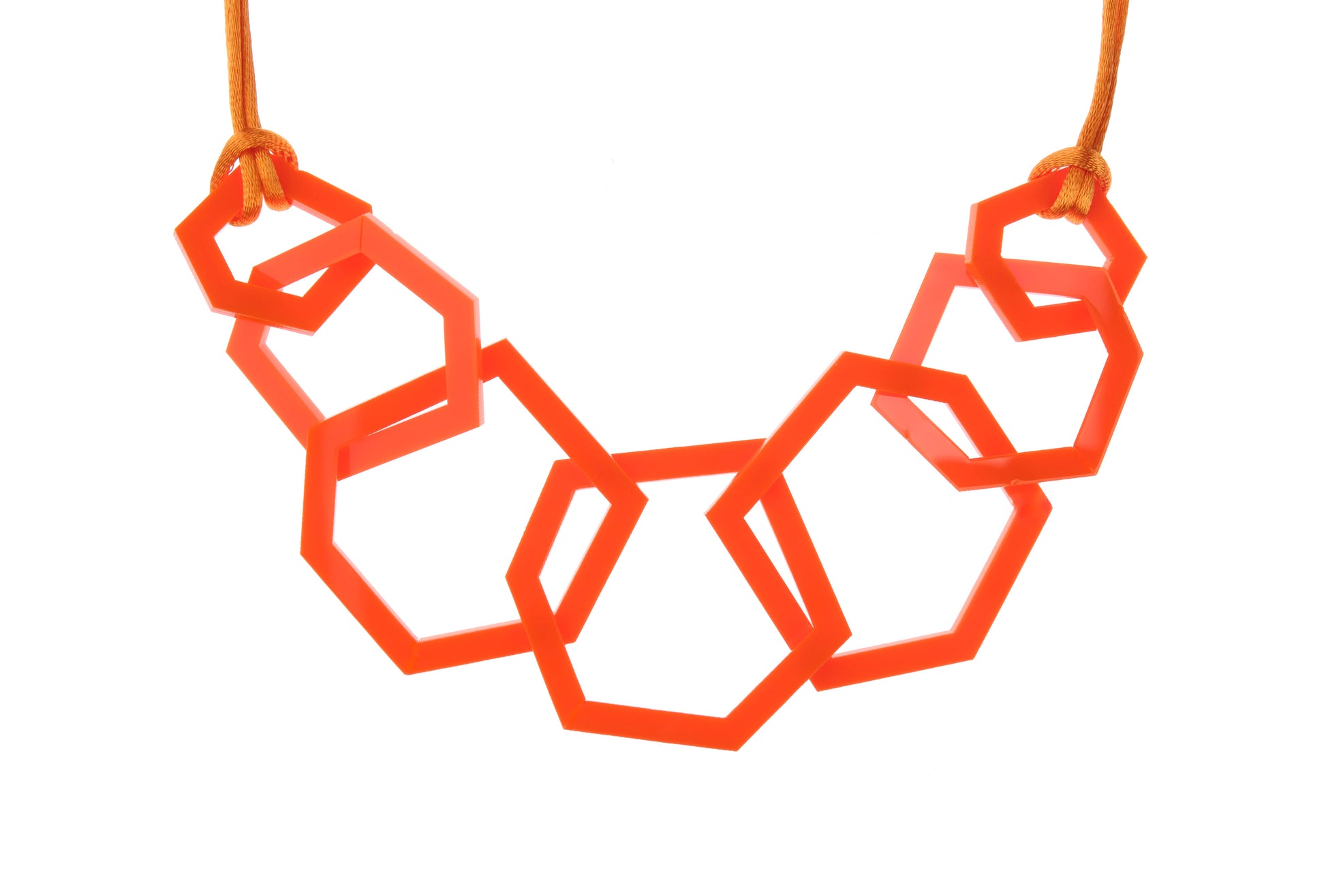 Geometric necklace with orange hexagonal links on a white background