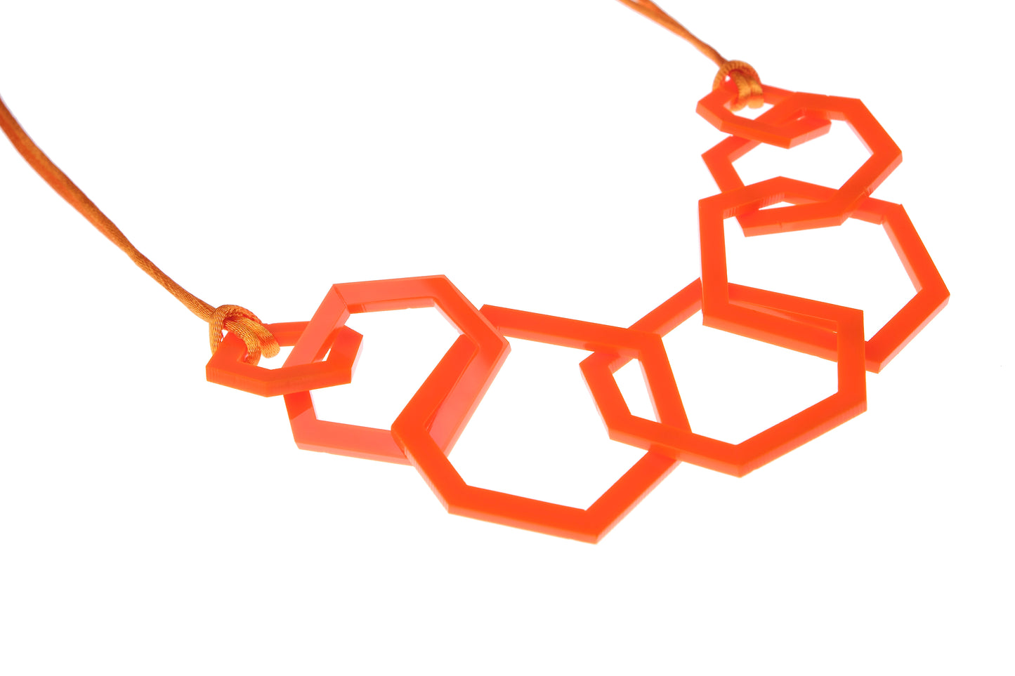 Orange geometric necklace on a white background
