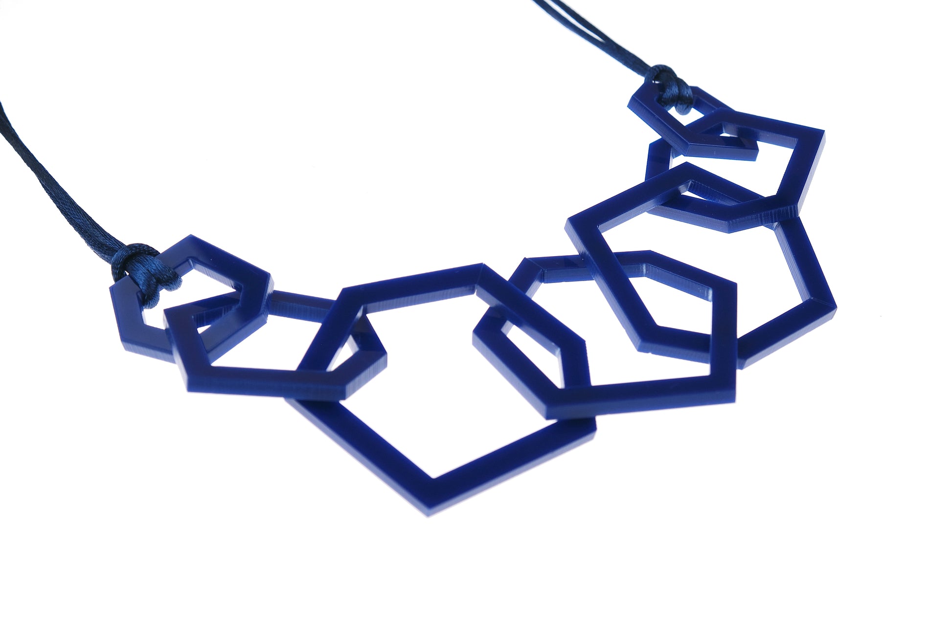 Navy Blue geometric necklace on a white background