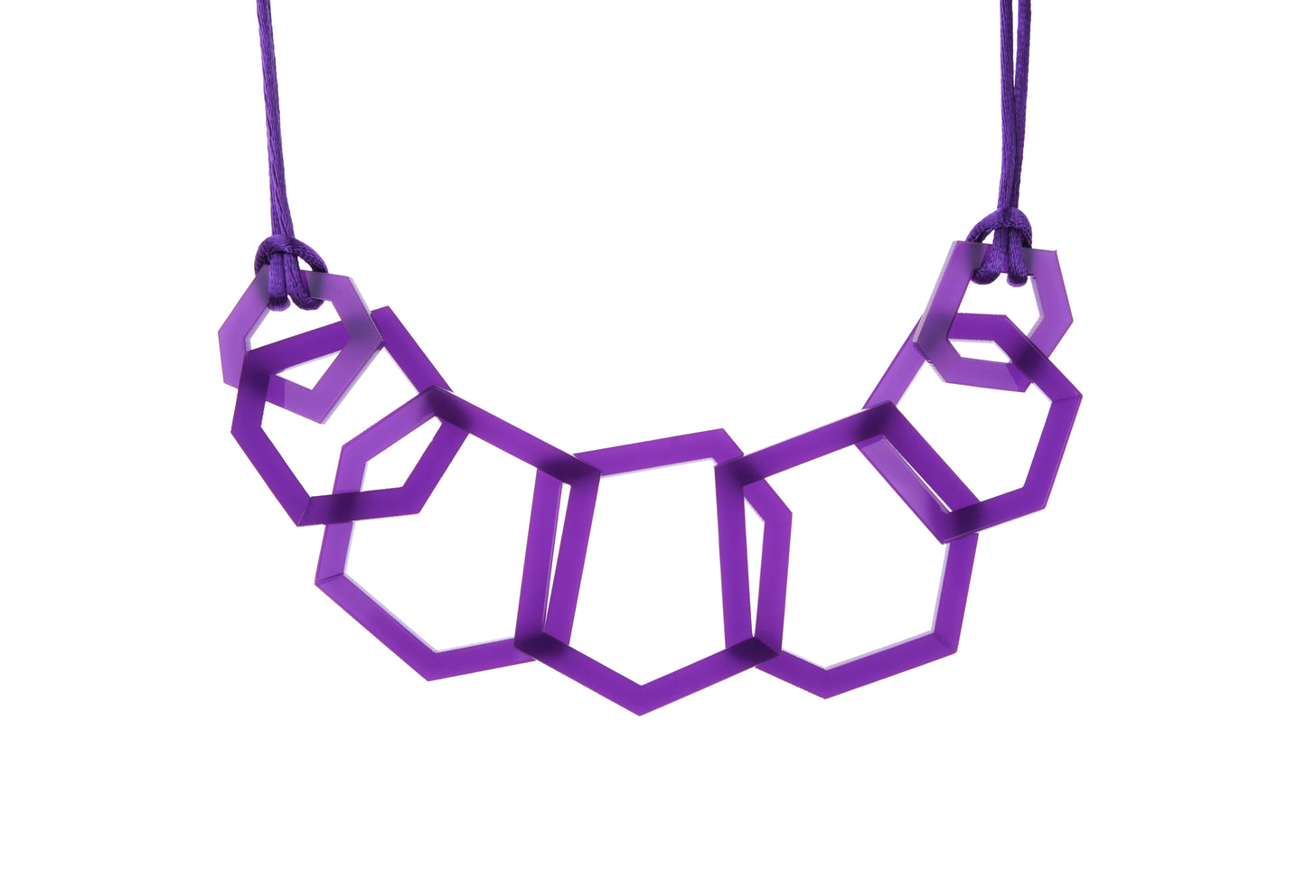 Detail of Purple geometric acrylic necklace on a white background