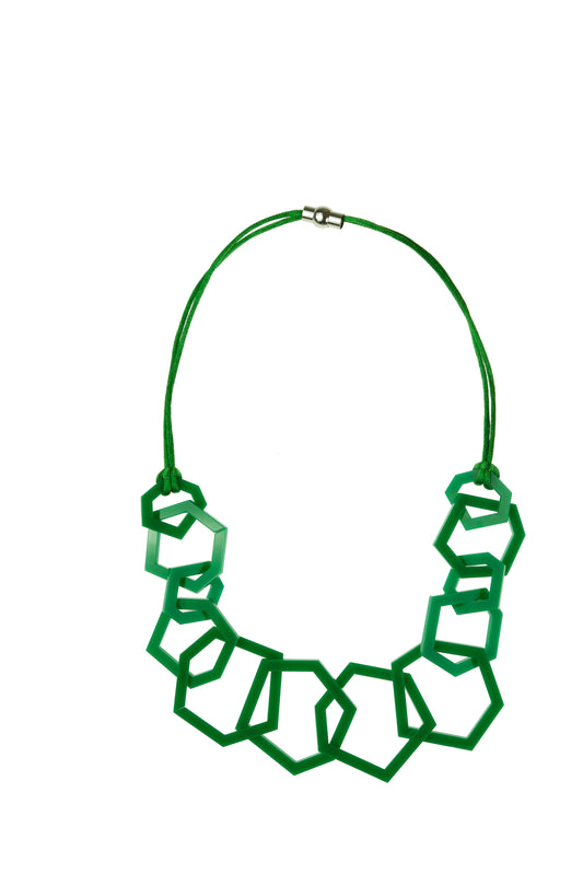 Green geometric necklace on a white background