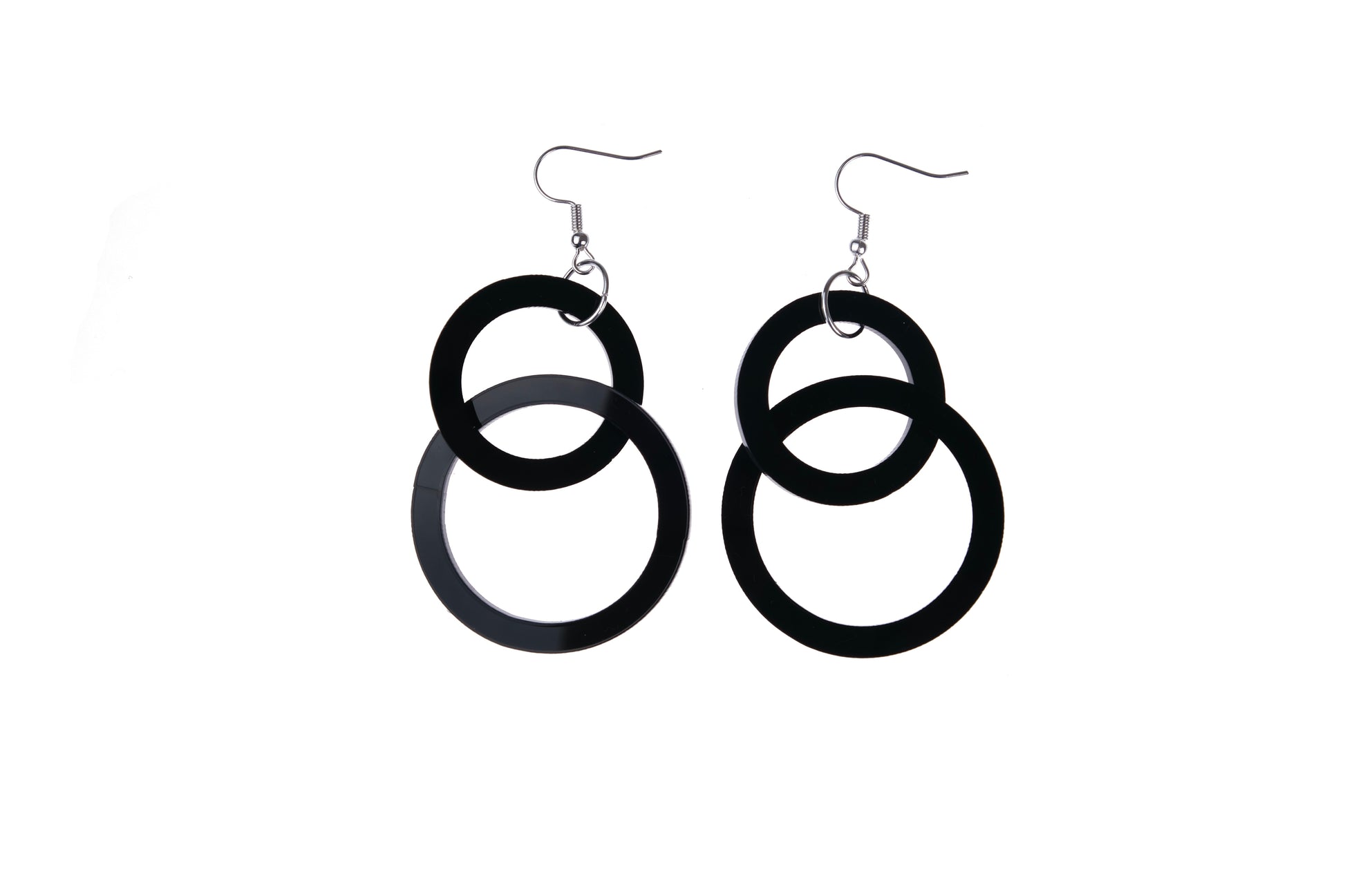 Black circular earrings on a white background