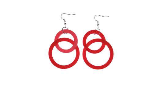 Red circular earrings on a white background