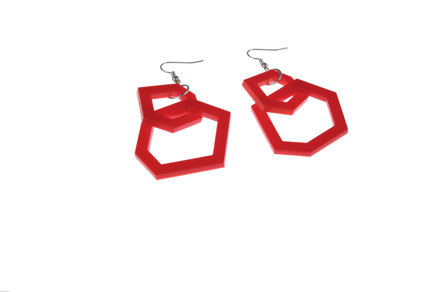 Red geometric earrings on a white background