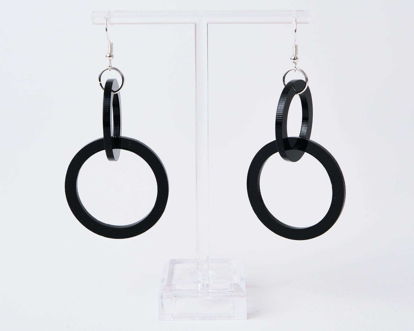 Black hoop earrings on a white background