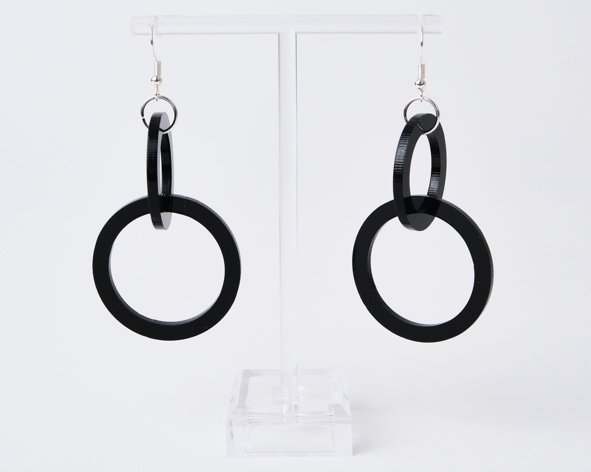 Black hoop earrings on a white background