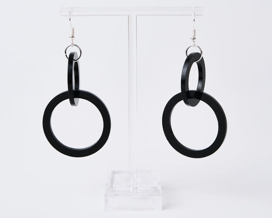 Black hoop earrings on a white background