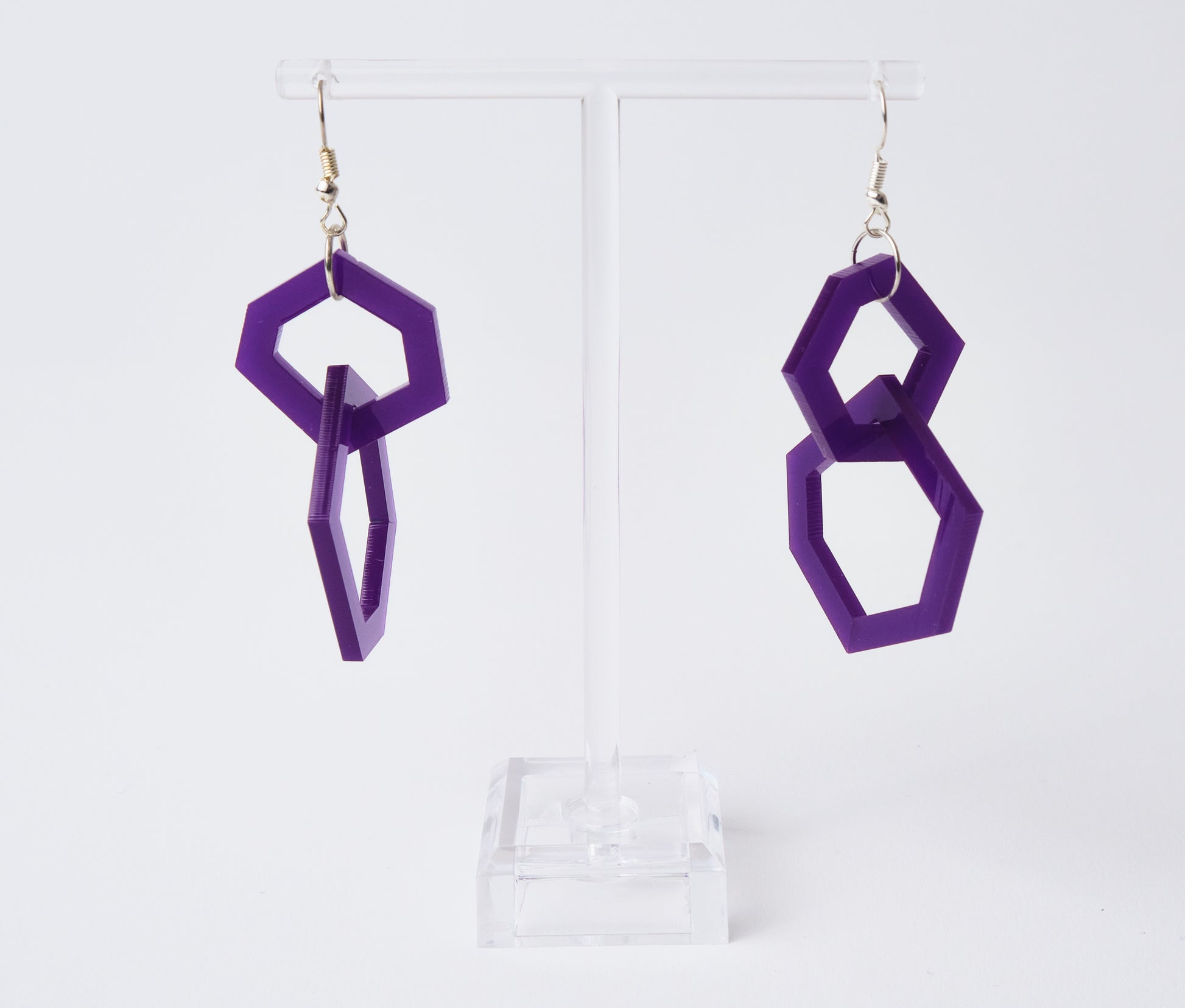Purple geometric earrings on a white background