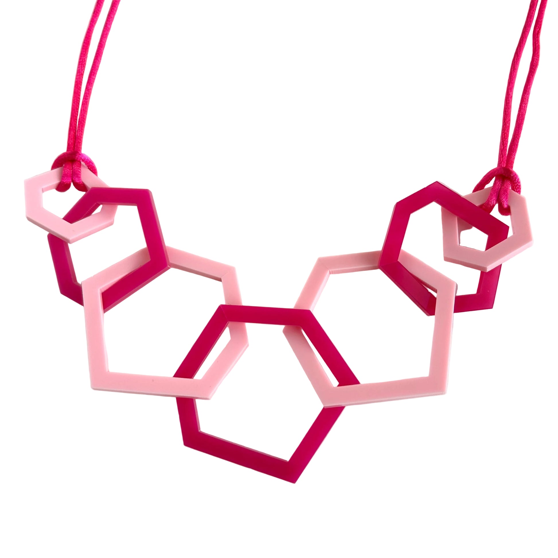 Necklace with pink geometric pendants on a white background