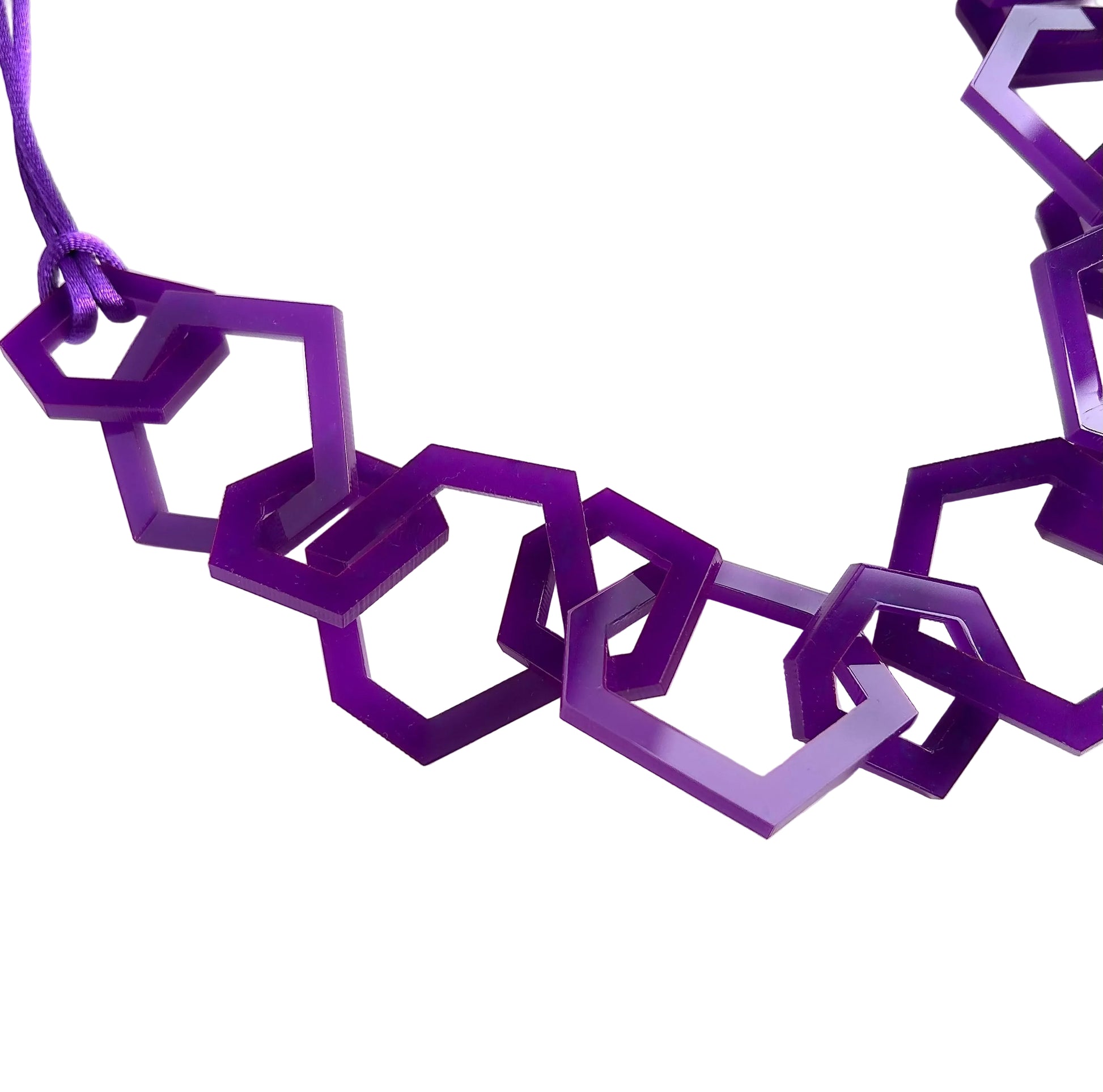 Purple geometric necklace on a white background
