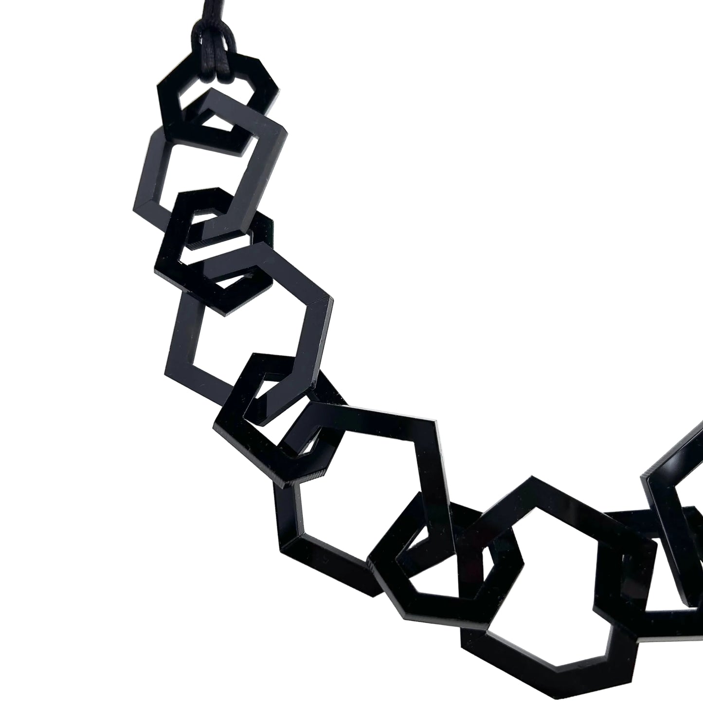black hexagon necklace on a white background