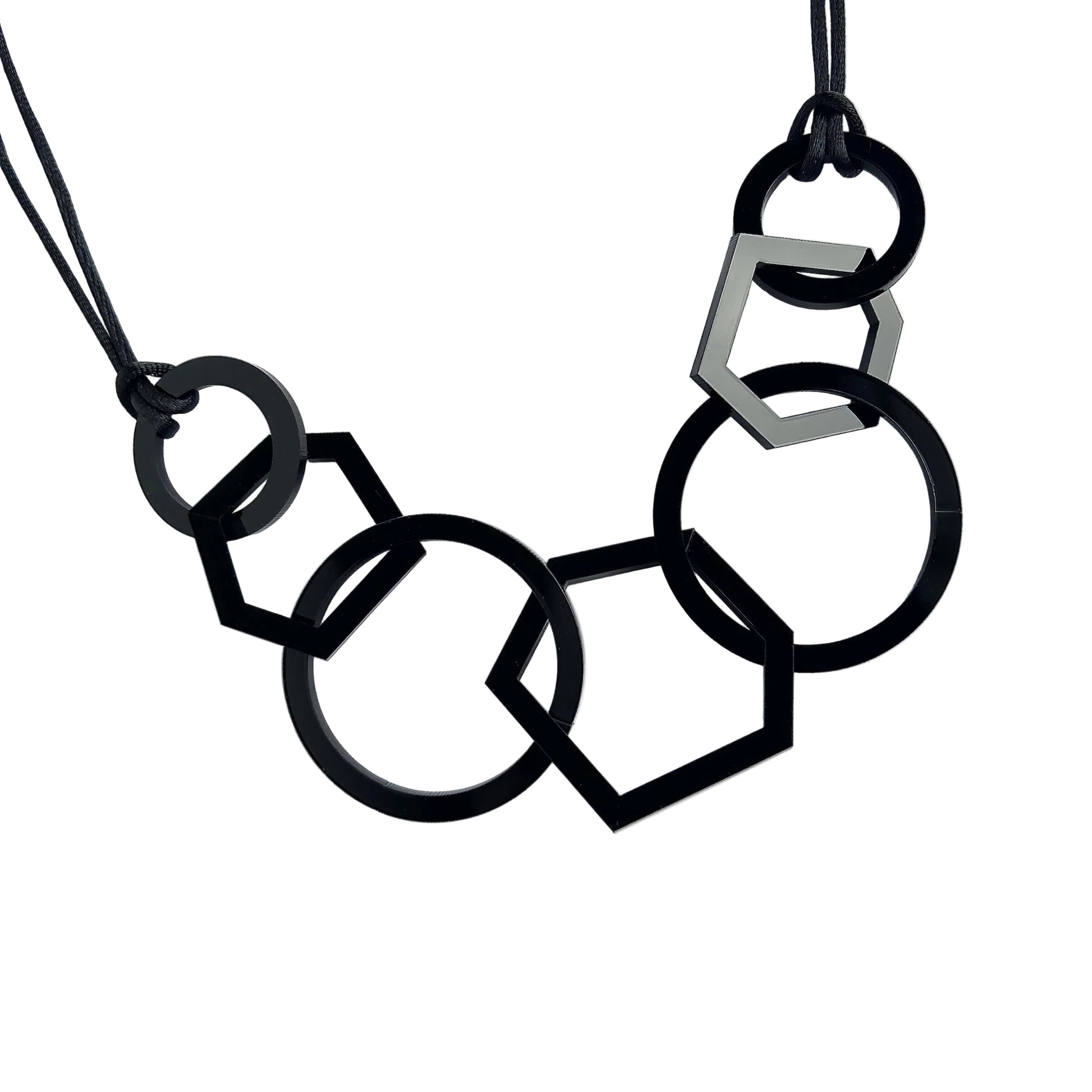 Black and silver geometric necklace on a white background