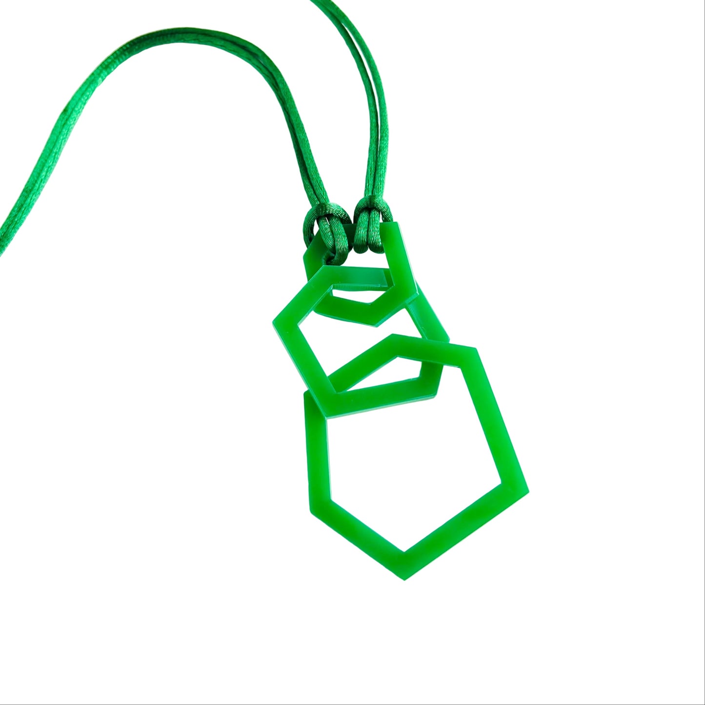 Green geometric pendant necklace on a white background