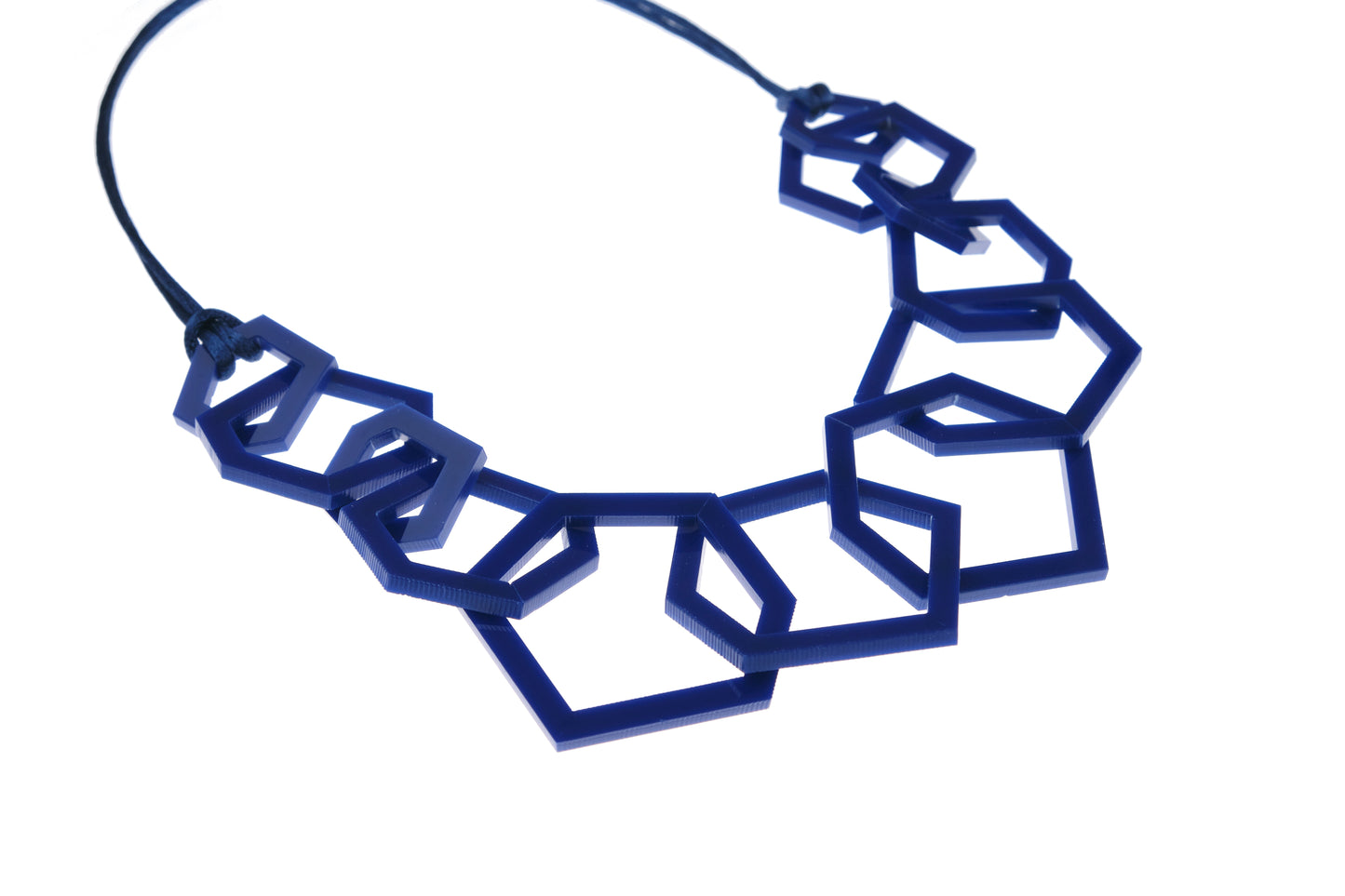 Navy Blue geometric necklace on a white background