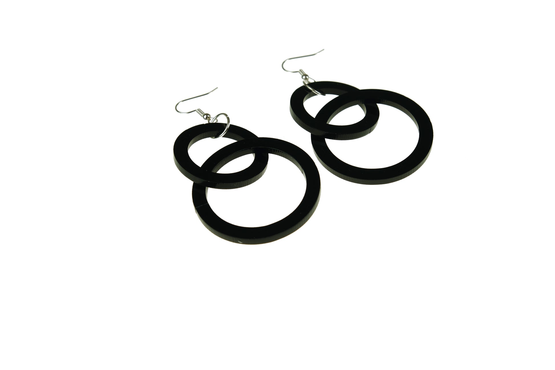 Black hoop earrings on a white background