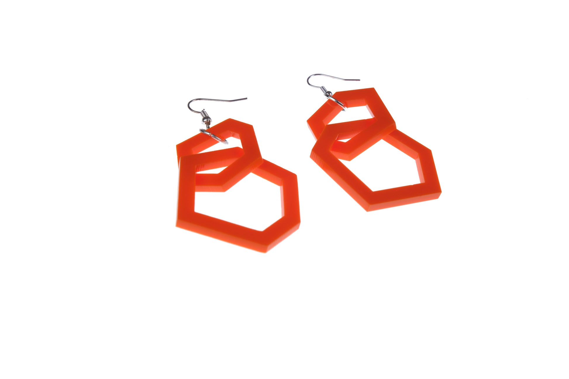 orange geometric earrings on a white background