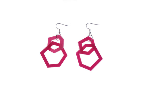 Pink geometric earrings on a white background