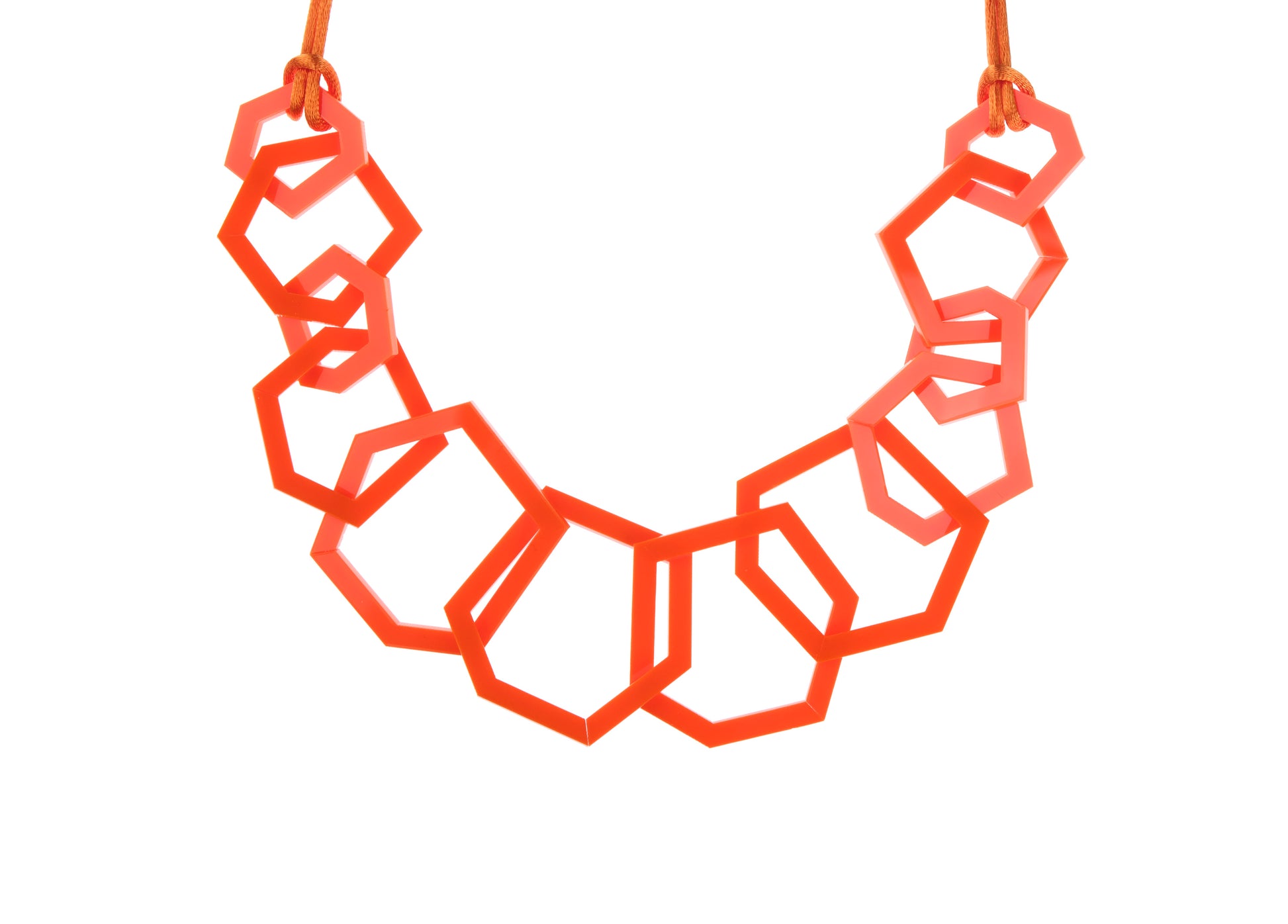 Geometric ornage necklace on a white background