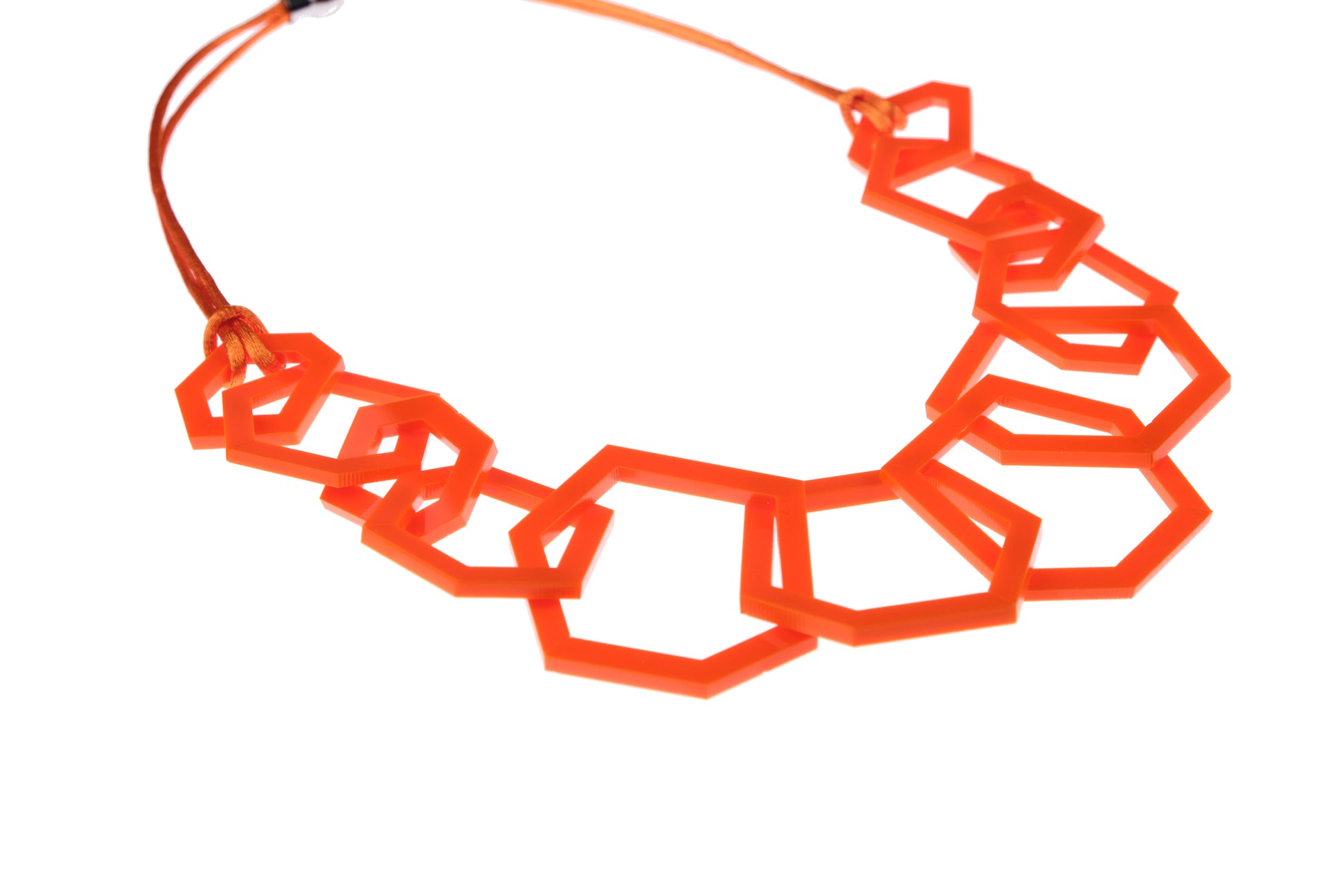 Orange geometric necklace on a white background