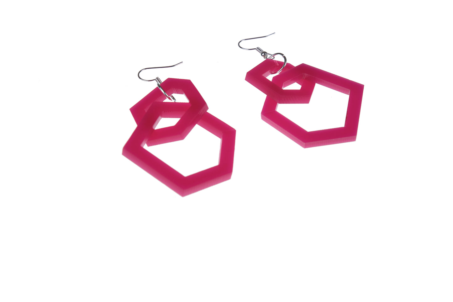 Pink geometric earrings on a white background