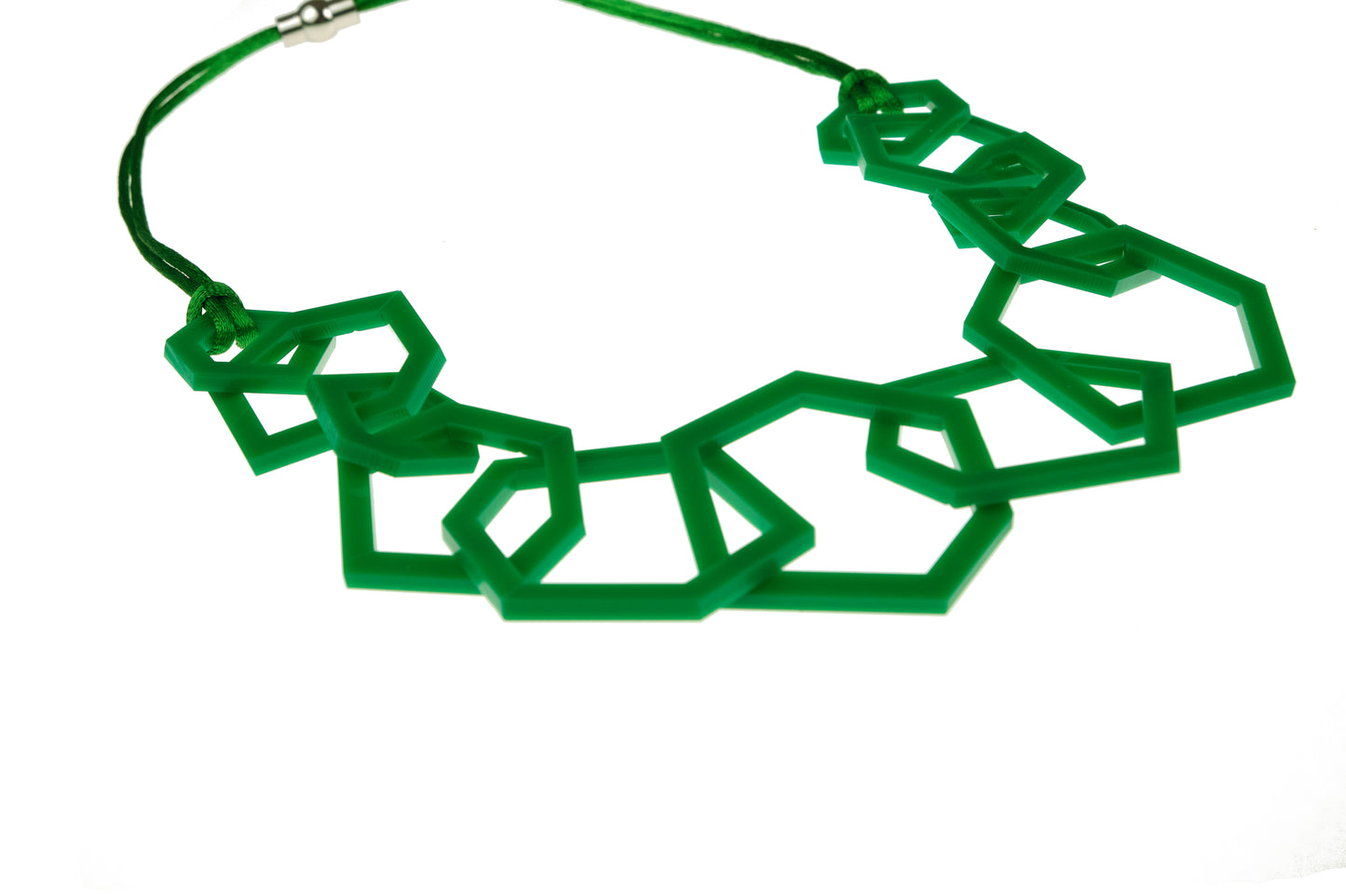 Green geometric necklace on a white background